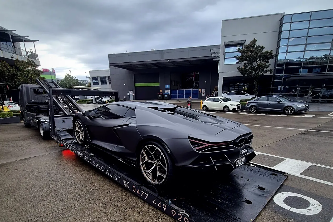 Matte grey Lamborghini secured on Haul King's branded tray