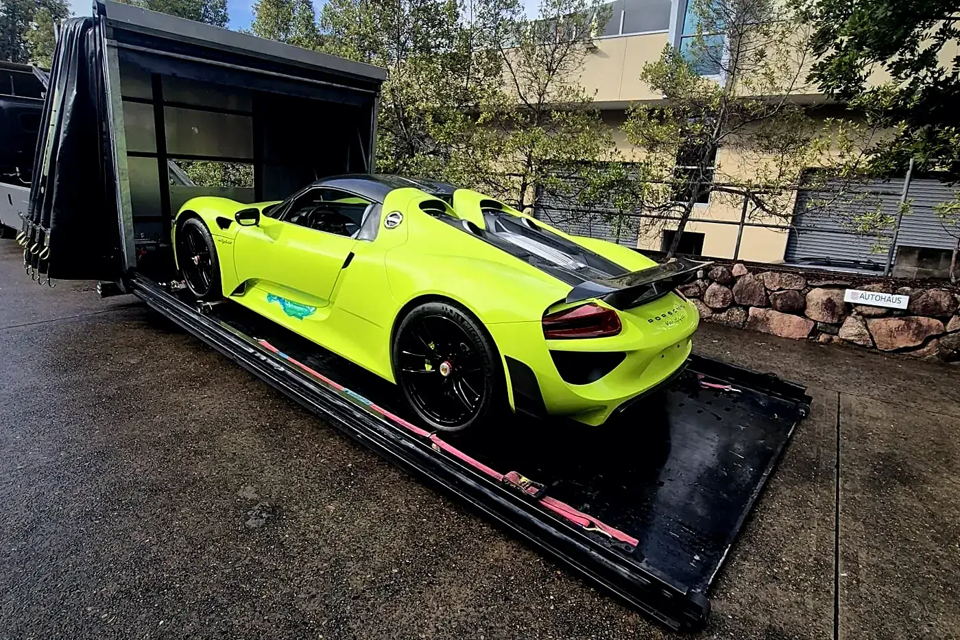 Acid green Porsche 918 Spyder inside Haul King's enclosed transporter