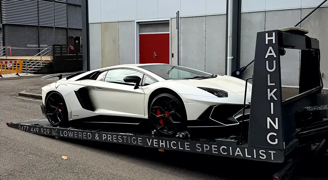 White Lamborghini Aventador secured on Haul King's branded low-angle tray, Sydney