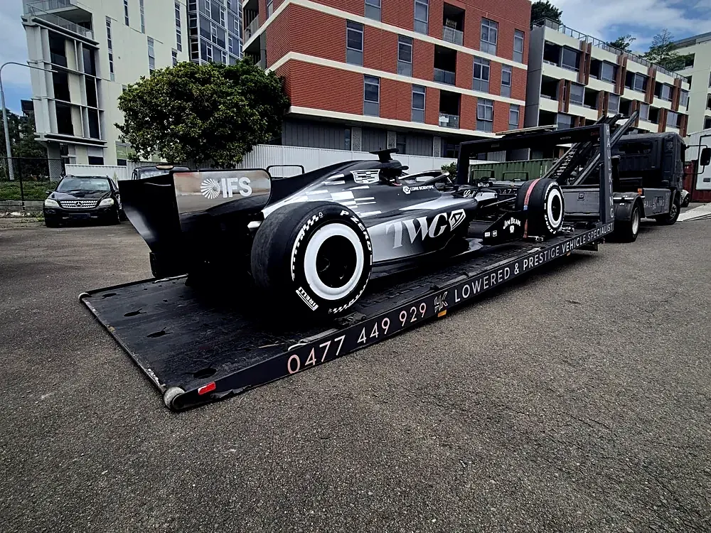 Single-seater race car secured on Haul King's low-angle tray